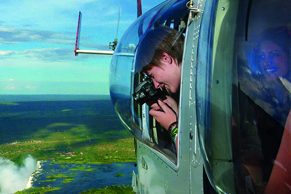 Board a helicopter and soar above the iconic Victoria Falls, marveling at the majestic sight from a breathtaking 180-degree perspective. Feel the rush of wind as you hover over the cascading waters, witnessing the sheer power and beauty of one of the world's most renowned natural wonders unfold beneath you.