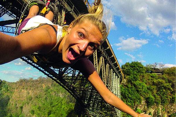 In the heart of Africa adventures at Victoria Falls, Zimbabwe, a courageous lady takes on the ultimate adrenaline rush: the gorge swing. With a sheer drop from the top of the gorge, she embraces the exhilaration, feeling the rush of freedom as she swings over the breathtaking abyss.