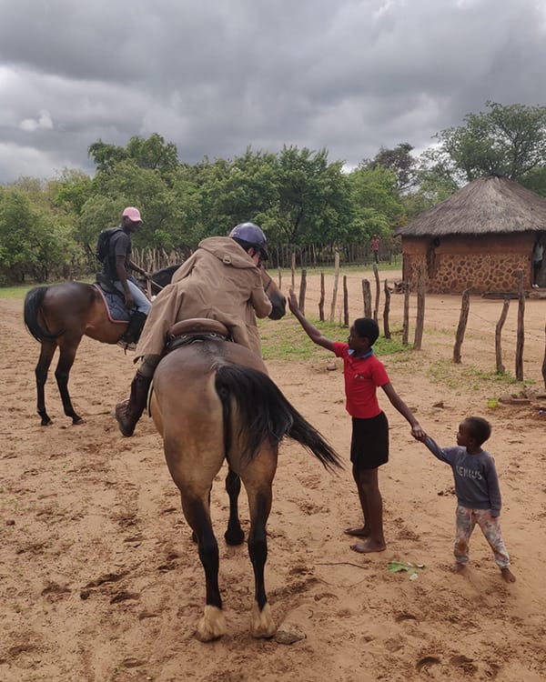 Horse riding volunteers engaging with the local community and caring for horses at Wild Bhiza Stables, Zimbabwe