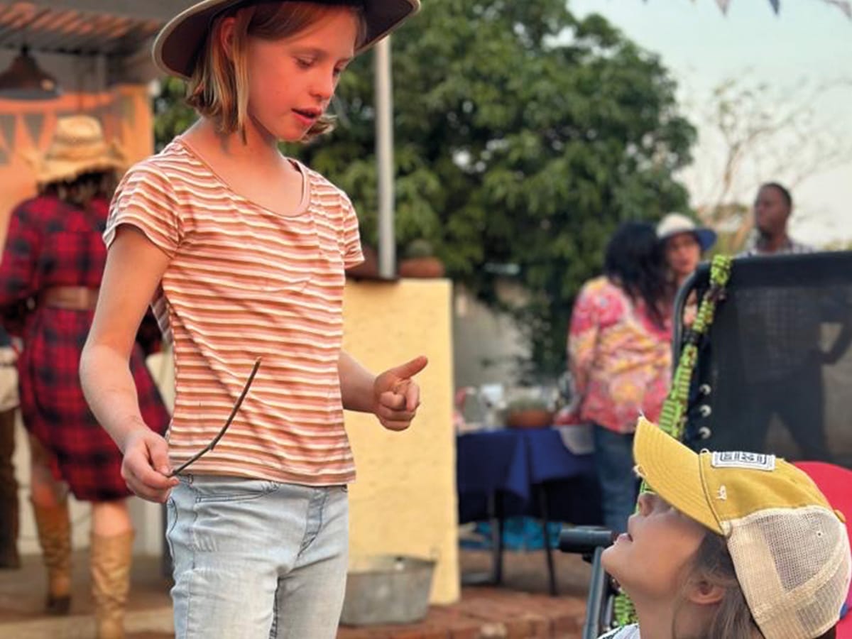 Children enjoying traditional braai gathering at Wild Bhiza African homestead Zimbabwe