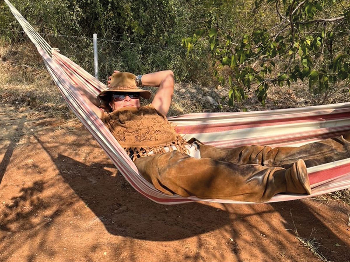 relaxing in hammock at Wild Bhiza accommodation with African landscape views Zimbabwe