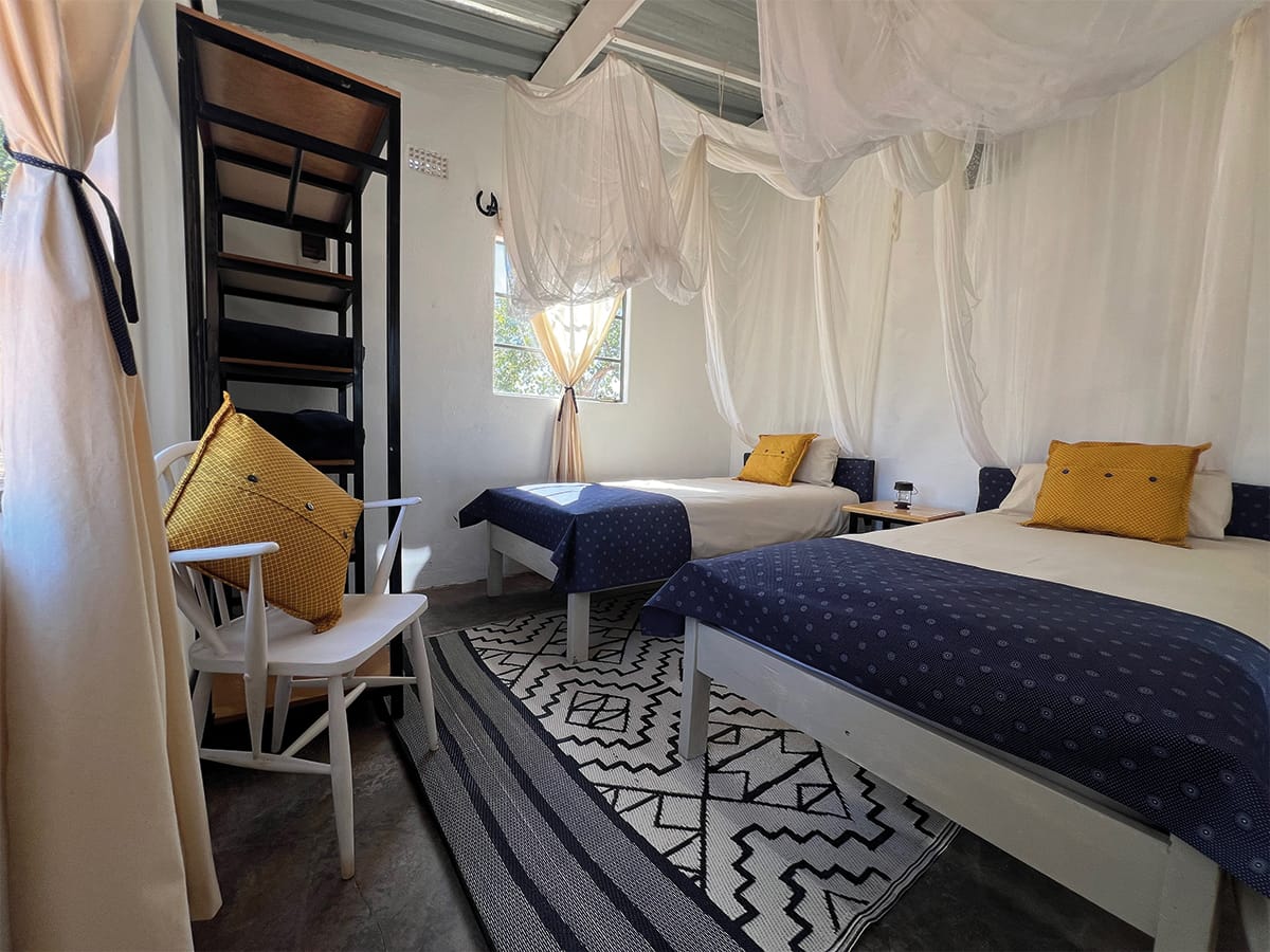 Comfortable twin bedroom with mosquito netting and modern amenities at Wild Bhiza accommodation Zimbabwe