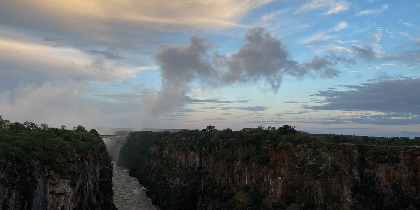 Victoria Falls gorge with rising mist and the Zambezi River flowing through dramatic cliffs Zimbabwe, showcasing world heritage natural wonder